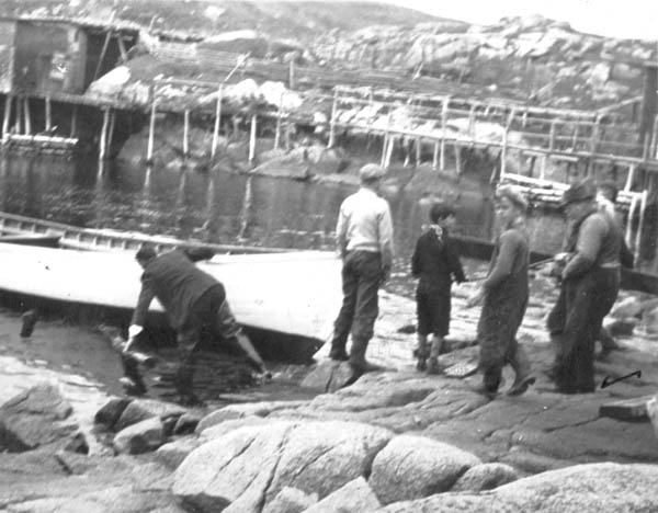 188: "This is our skiff when they were launching her this spring on the Island. Pop is pushing the  stick under the skiff" (written on the back of the photo). l-r J V McCarthy, Bernard Mulrooney,  John Webber, Cyril Whelan and James Reddy. The skiff is the "St. Bernadette". (1942)  [courtesy of Madonna (Healey) McCarthy]  - J V son of Thomas McCarthy &amp;amp; Anastasia Fitzgerald; Bernard son of Patrick Mulrooney &amp;amp;  Ellen Pierson; John son of John Webber &amp;amp; Mary Emberly; Cyril son of Thomas Whelan &amp;amp;  Anastasia Barry; James son of Michael Reddy &amp;amp; Eliz Fagan